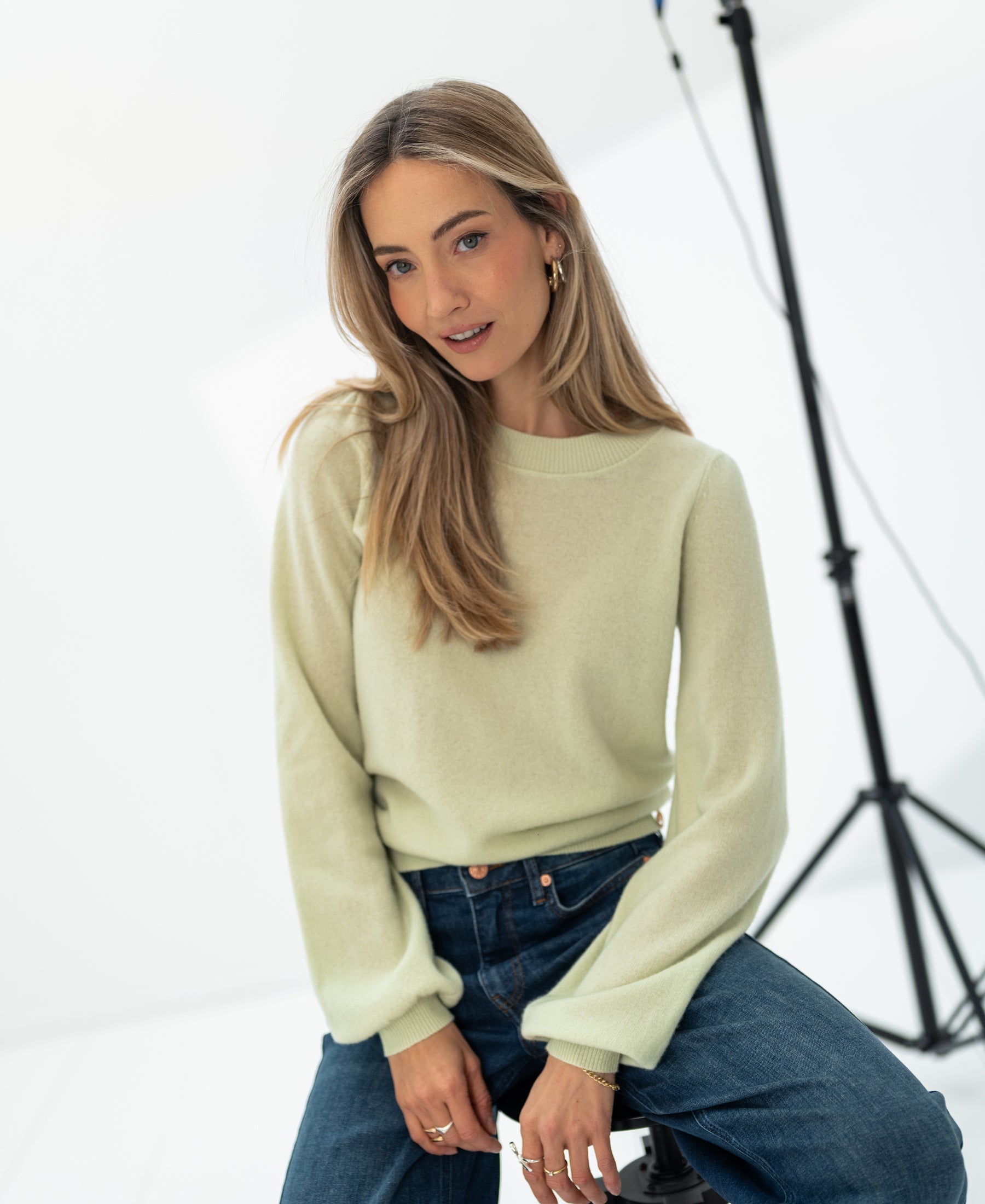 Light green soft merino wool sweater in a bright studio.