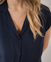 Sleeveless dark blue blouse shown from neck to mid-torso.