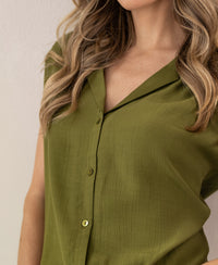 Sleeveless olive green blouse shown mid-torso.