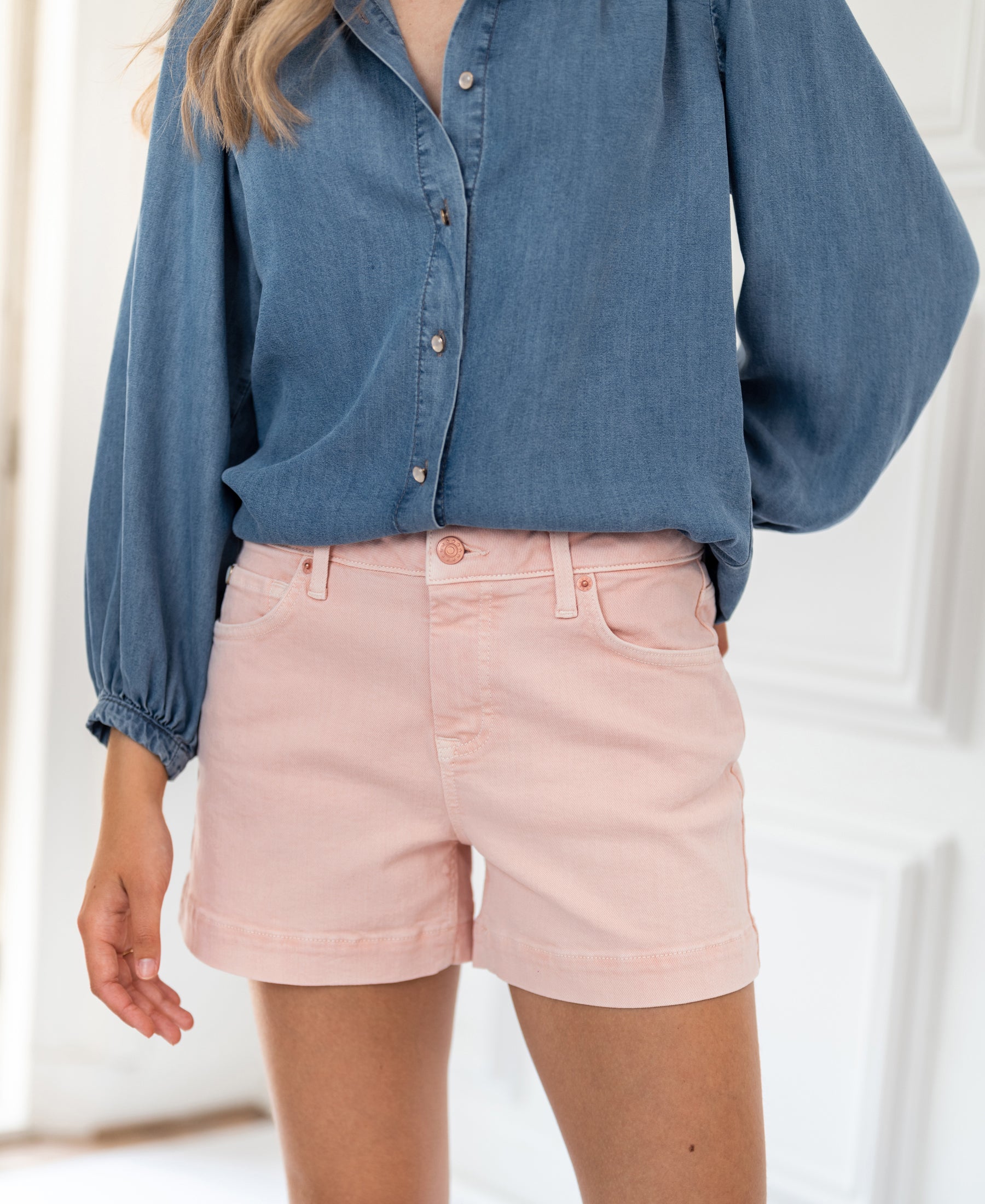 Blush pink LA BILLY shorts displayed indoors.
