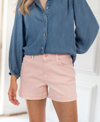 Blush pink LA BILLY shorts displayed indoors.