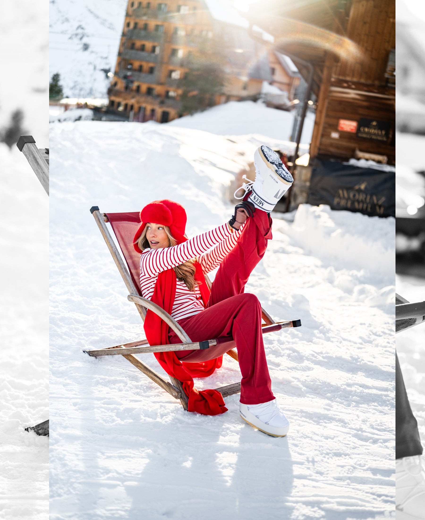 Woman smiling and relaxing on a deck chair, wearing SOLD OUT Lounge pants in red.