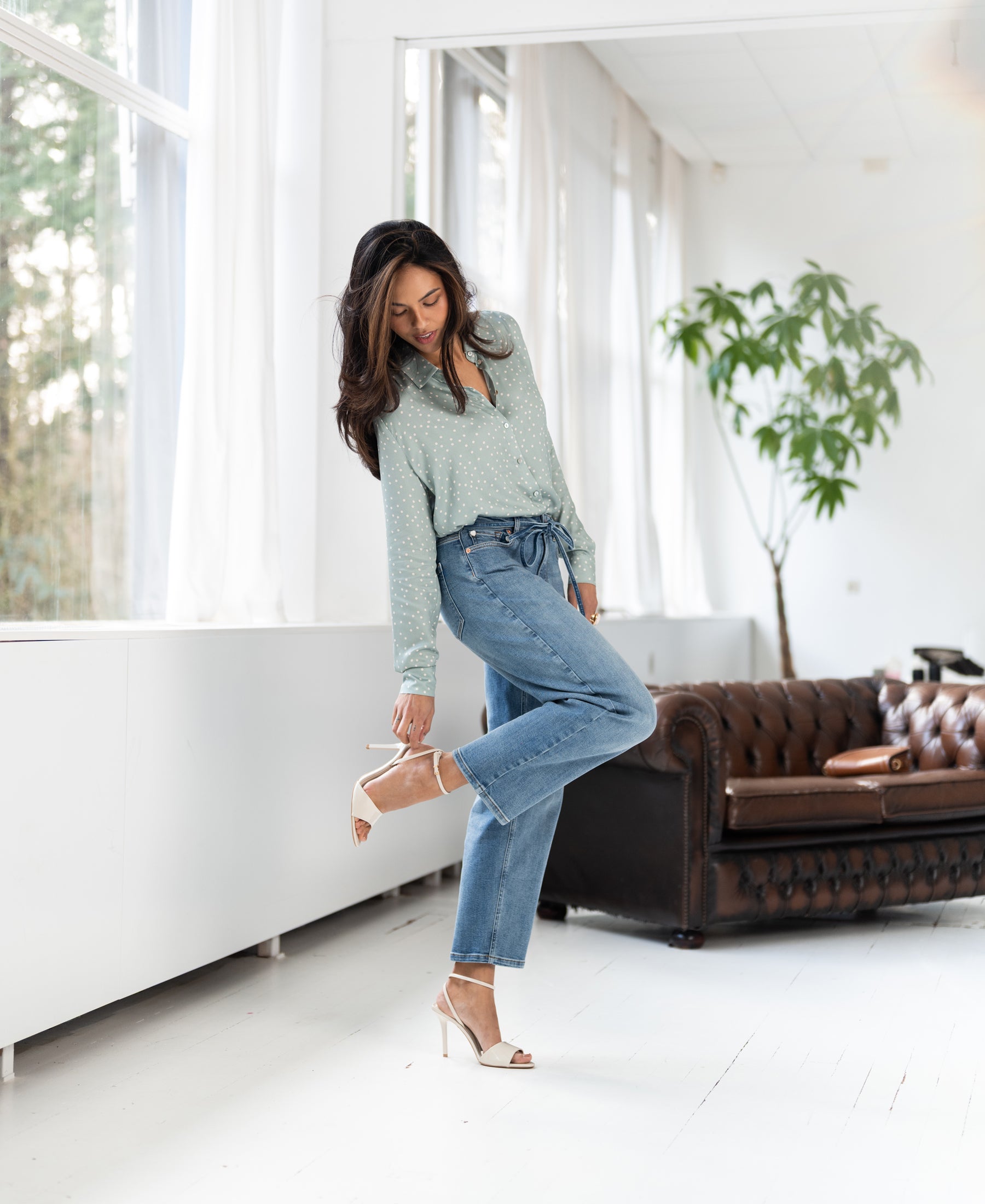 Light stone cropped jeans in a bright room.