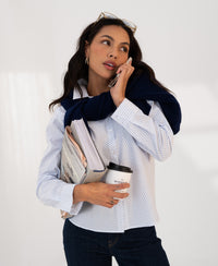 Woman wearing white and light blue striped blouse, front view.