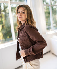 Stretch denim jacket in cocoa brown shown indoors, back view.