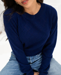 Navy argyle merino wool sweater, upper body view, face partially out of frame.