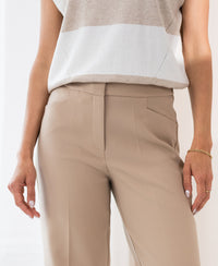 Wide-leg pants in light sand from PLEIN PUBLIQUE, shown on a model.
