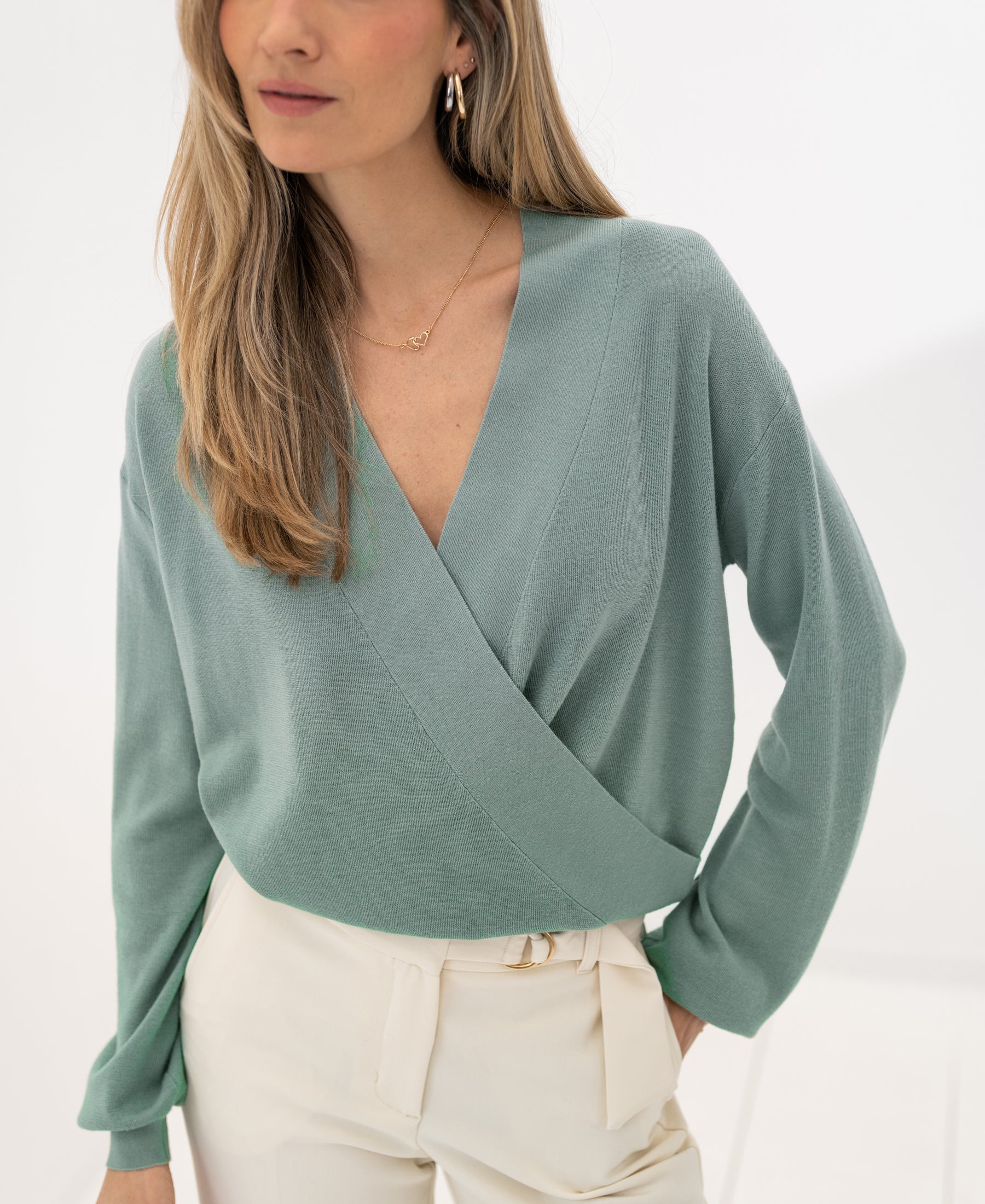 LES CINQ sage green wrap sweater by PLEIN PUBLIQUE shown against a white background.