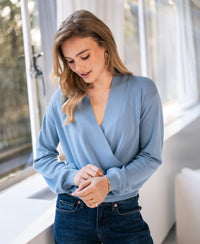 Oversized wrap sweater LES CINQ by PLEIN PUBLIQUE in view near a window.