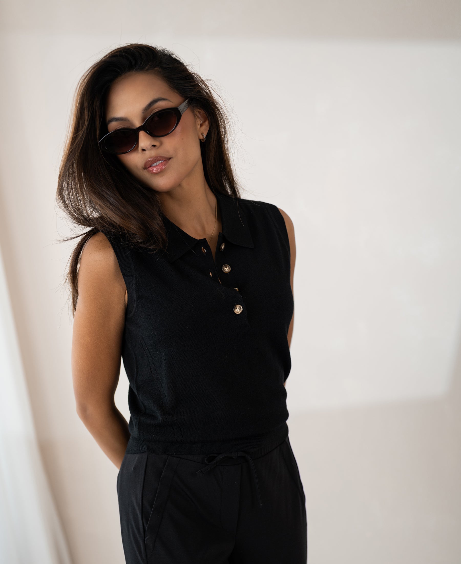 Sleeveless black LE CLUB polo sweater by PLEIN PUBLIQUE shown indoors against a neutral background.