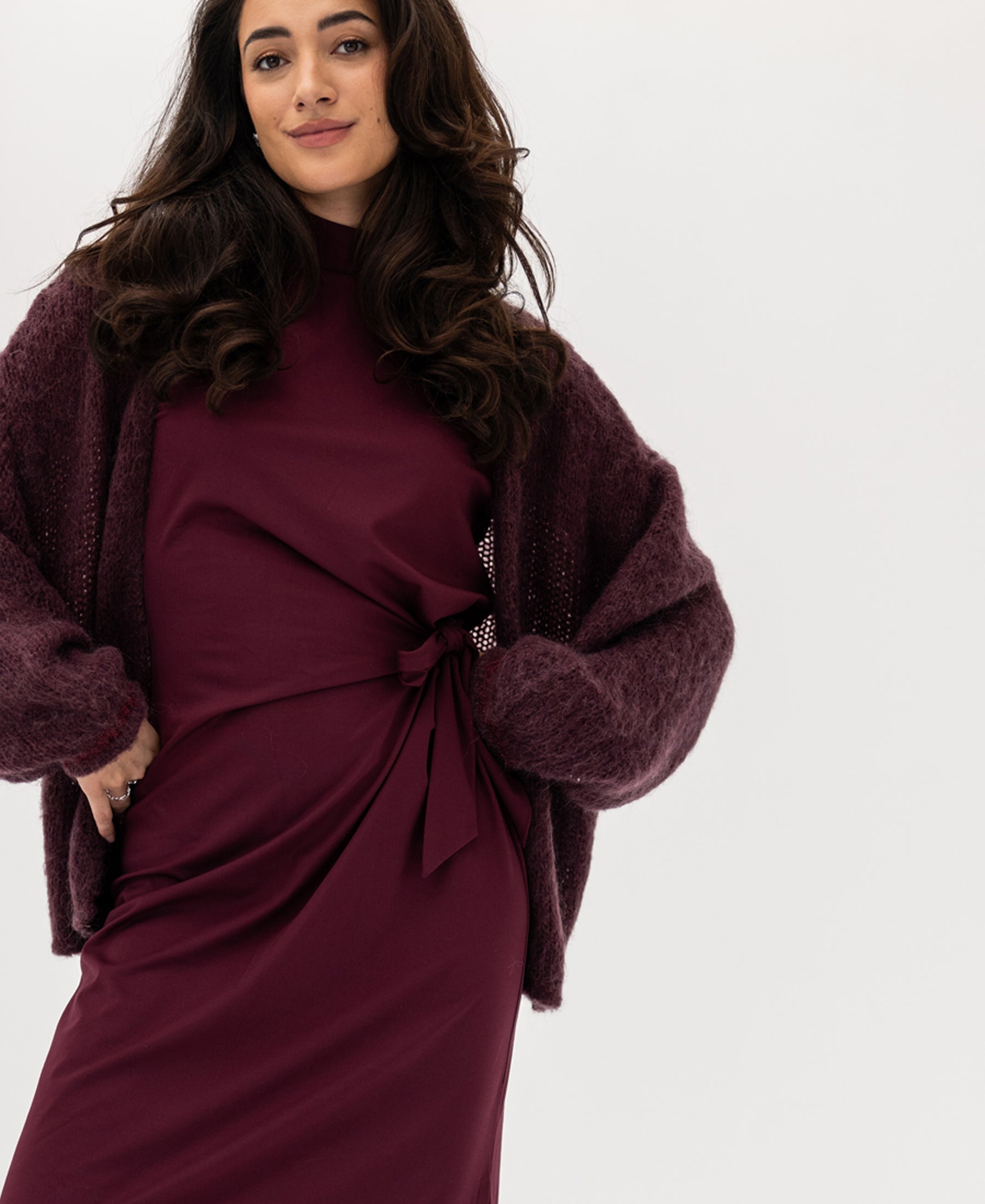 Woman wearing the Fluffy Vest in Bordeaux, standing against a white background.