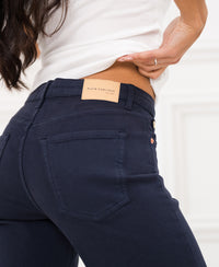 Close-up of the leather label on the waistband of LES DEUX dark blue jeans.