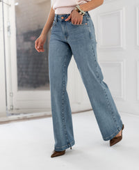 Wide leg jeans in light stone color from Les Deux, shown indoors near a white door.