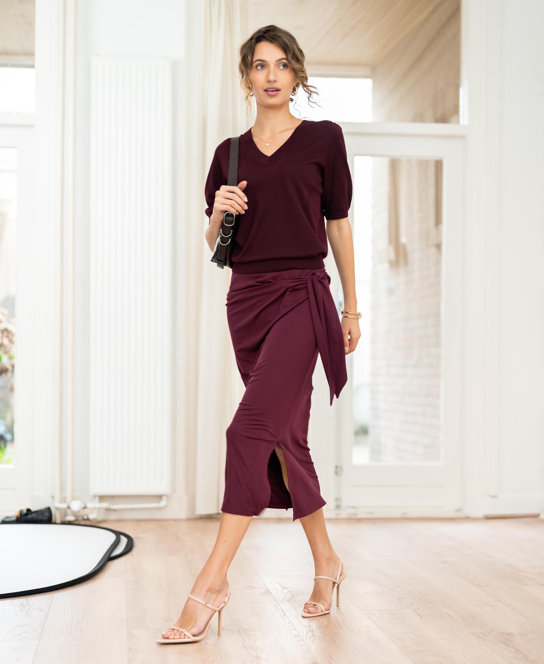 Wine-colored Travel skirt by Plein Publique, shown indoors.