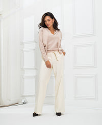 Blush LA DOUBLE Cardigan by PLEIN PUBLIQUE shown in a light room with white panel walls.