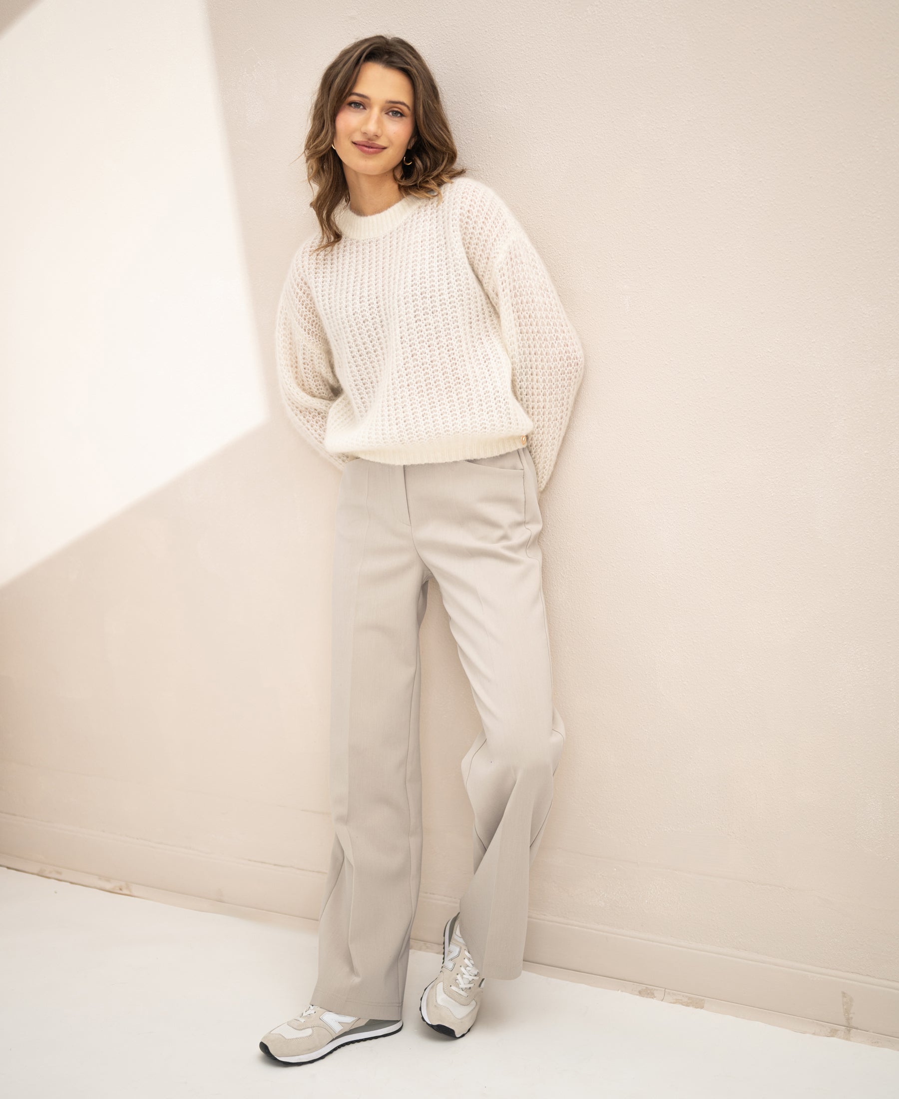 Semi-oversized ivory white mohair sweater, shown worn with hands in pockets.