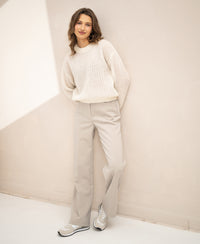Semi-oversized ivory white mohair sweater, shown worn with hands in pockets.