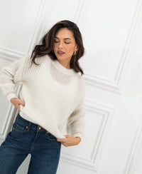Ivory white mohair sweater by PLEIN PUBLIQUE shown on a person standing in front of a white paneled wall.