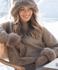 Cozy semi-oversized mohair sweater in sand color, shown outdoors in snowy setting.