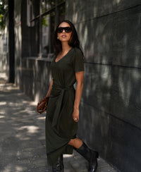 Dark olive green long dress in lightweight fabric from PLEIN PUBLIQUE, shown worn by a woman.