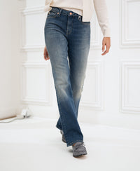 Blue vintage LES FLARES jeans, lower body view, photographed on a person indoors against a white background.