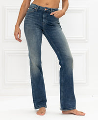 Blue vintage flare jeans displayed against a white background.