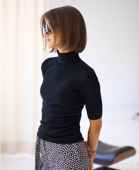 Black short-sleeve turtleneck sweater.