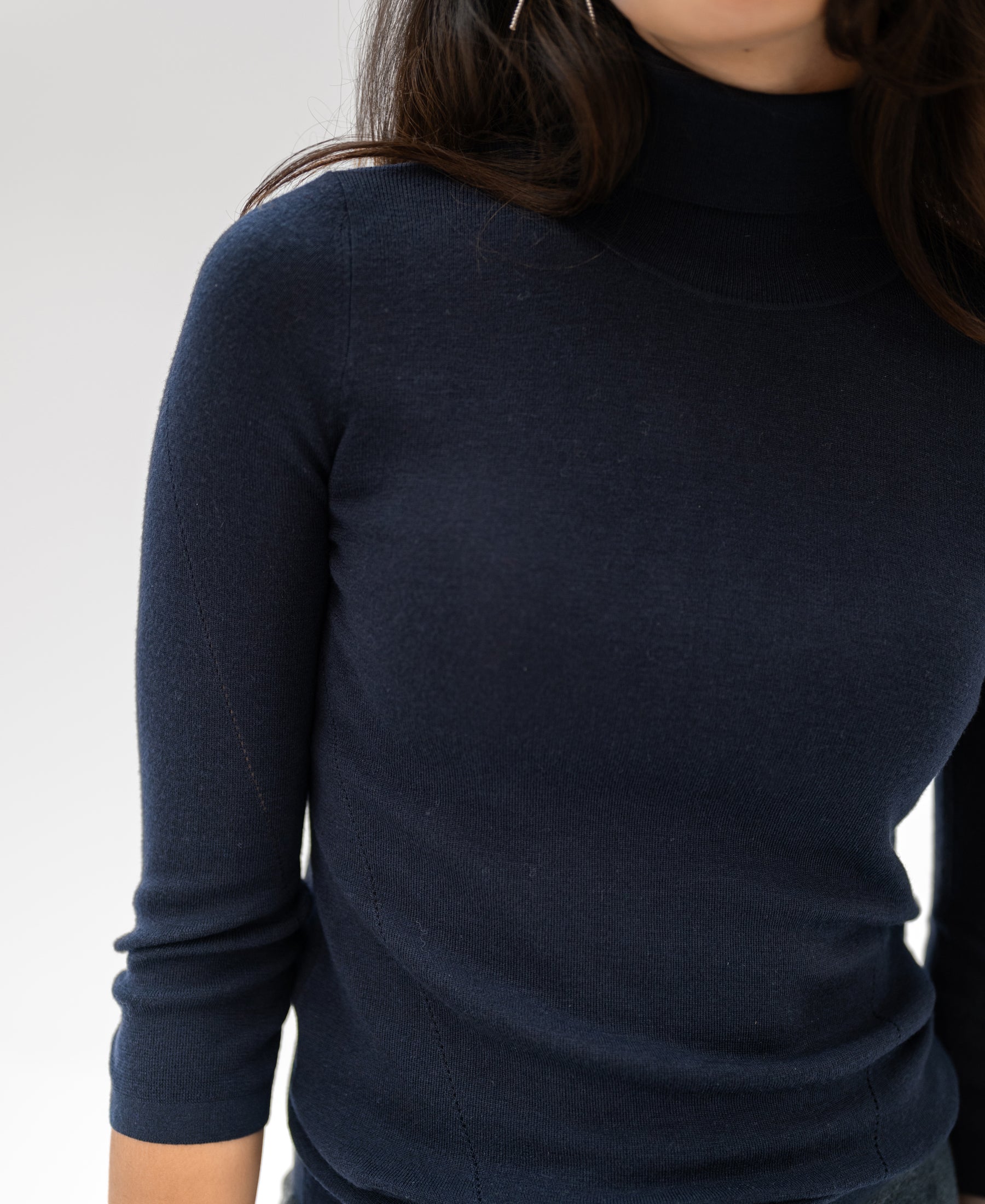 Navy LE FABIAN turtleneck sweater by PLEIN PUBLIQUE, shown from shoulders to waist against a light background.