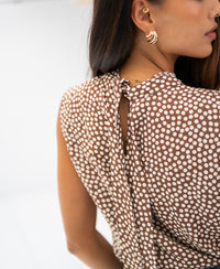 Rear view of woman wearing mocha mousse-cream LA GIVERNY dotted top by PLEIN PUBLIQUE.