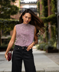 Woman with long brown hair wears the LA GIVERNY cream polka dot blouse top by PLEIN PUBLIQUE.