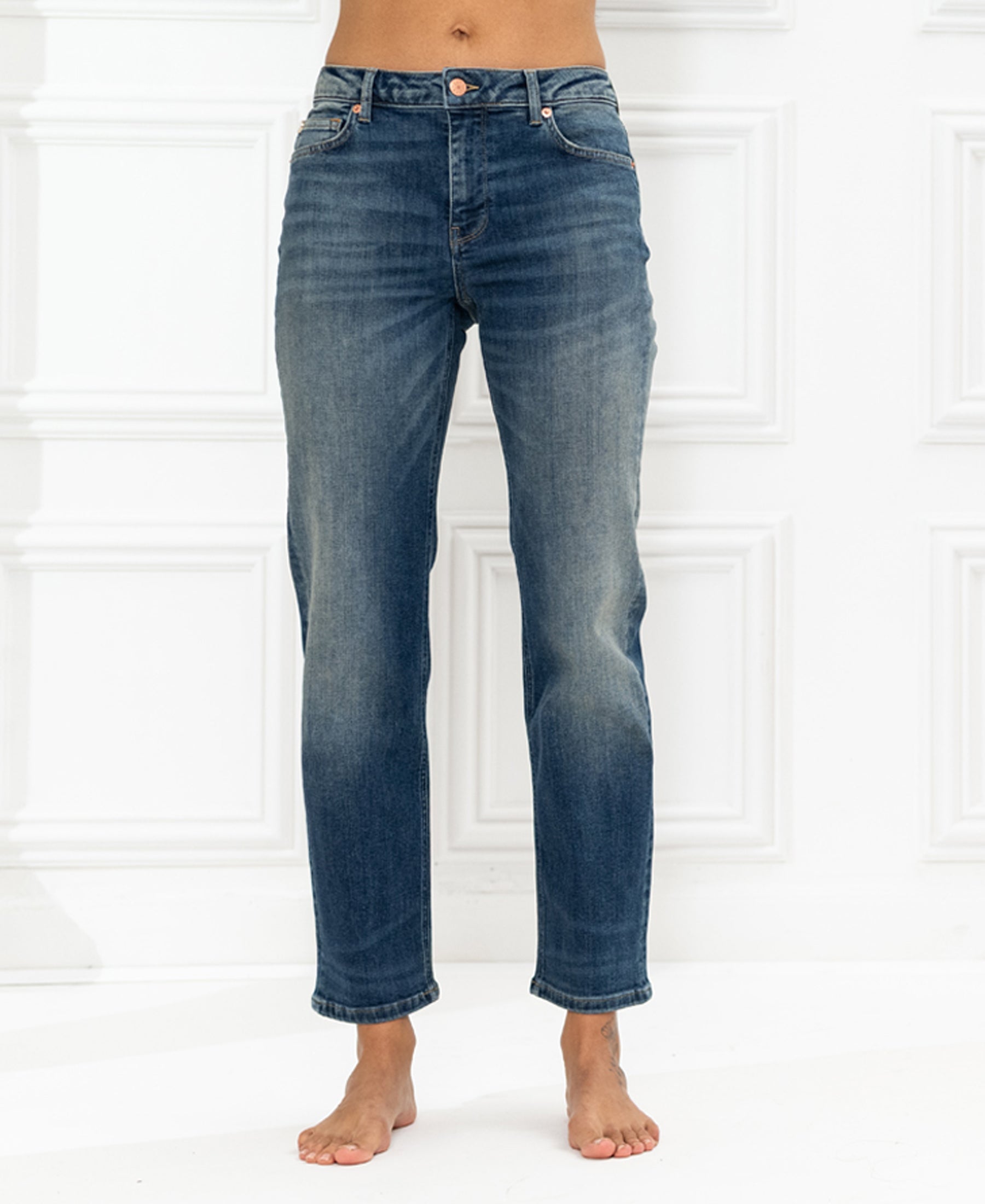 Blue vintage cropped jeans by PLEIN PUBLIQUE, LE GUY style, shown against a white paneled wall.