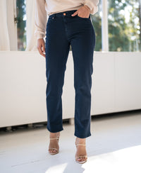 Cropped jeans in dark blue shown on a model against a white background.