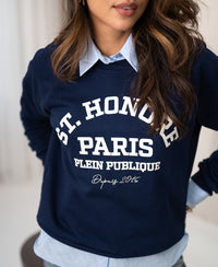 Woman wearing a dark blue PLEIN PUBLIQUE LA HARPER St. Honore sweater.