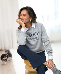 Light grey LA HARPER sweater by PLEIN PUBLIQUE shown indoors.