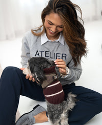 Light grey LA HARPER sweater by PLEIN PUBLIQUE shown indoors.