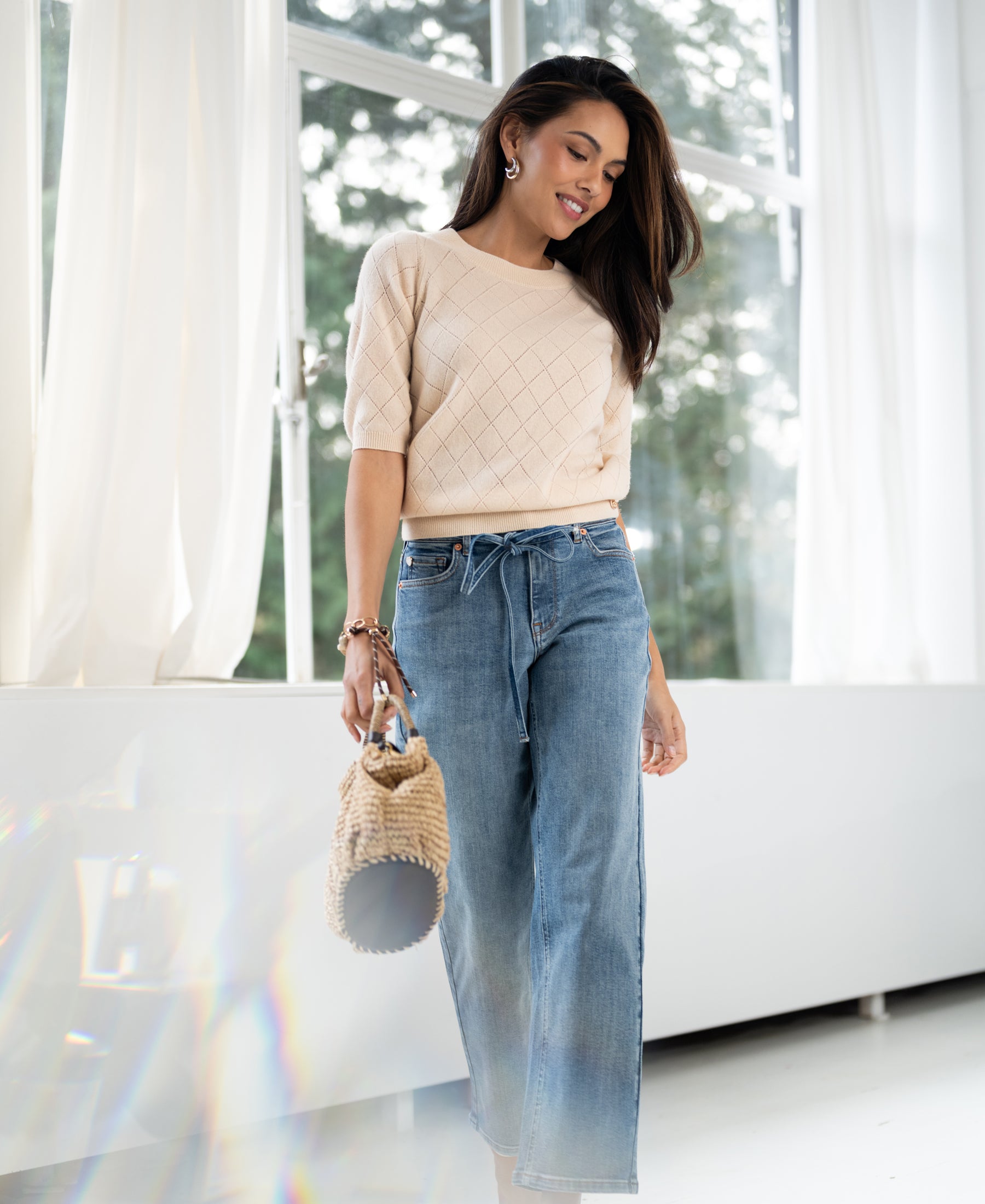 Light stone cropped jeans in a classic fit, shown worn indoors.