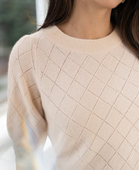 Short-sleeved Argyle merino sweater in butter yellow, shown shoulder to chest.