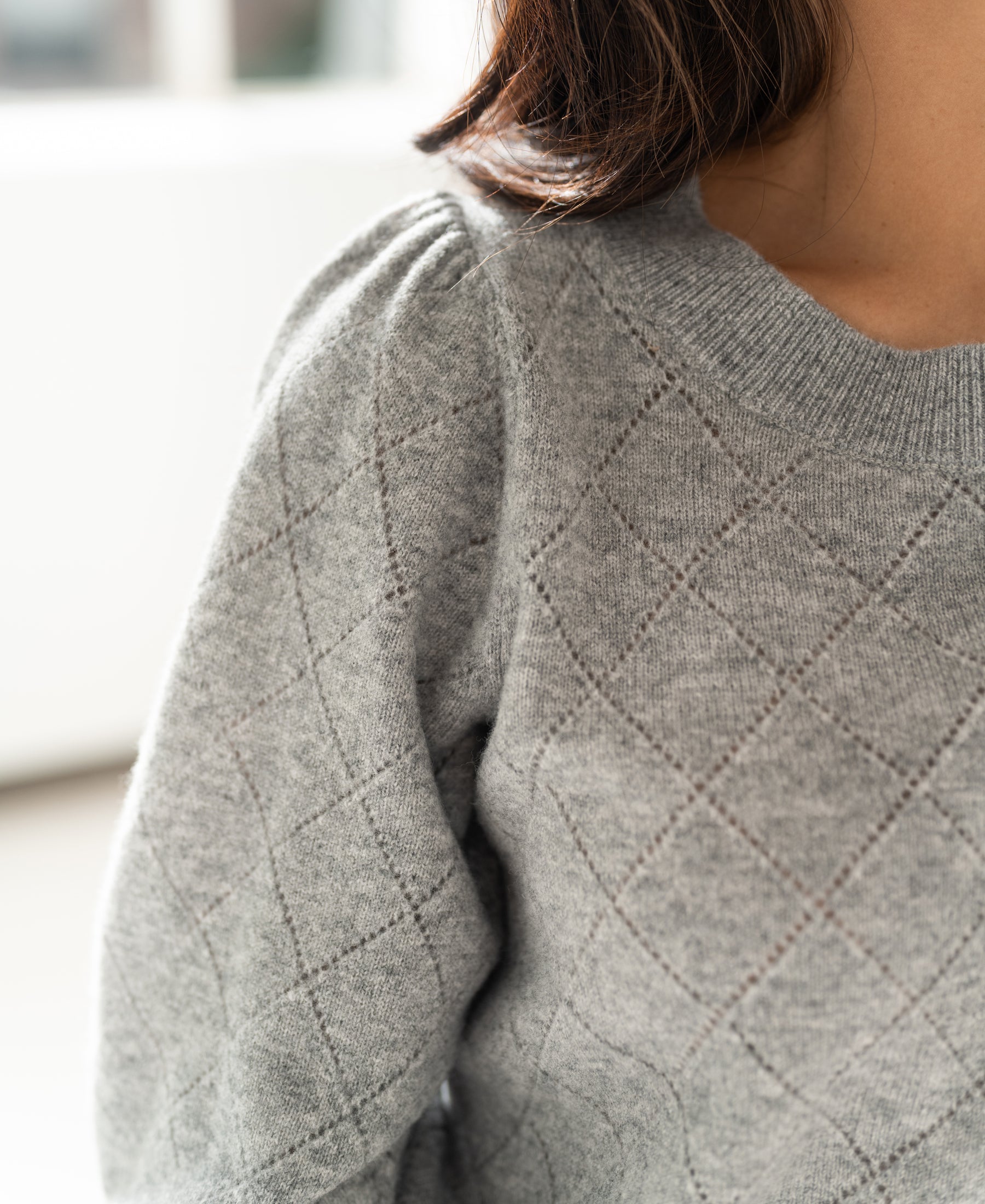 Close-up of the LE HARVARD Grey Argyle merino sweater by PLEIN PUBLIQUE showing shoulder details.