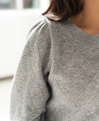 Close-up of the LE HARVARD Grey Argyle merino sweater by PLEIN PUBLIQUE showing shoulder details.
