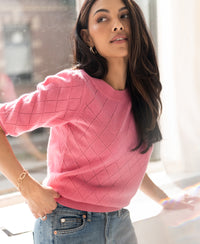 Pink argyle merino wool sweater LE HARVARD by PLEIN PUBLIQUE shown in side view.