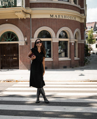 Woman wearing a black PLEIN PUBLIQUE Travel polo dress INES.