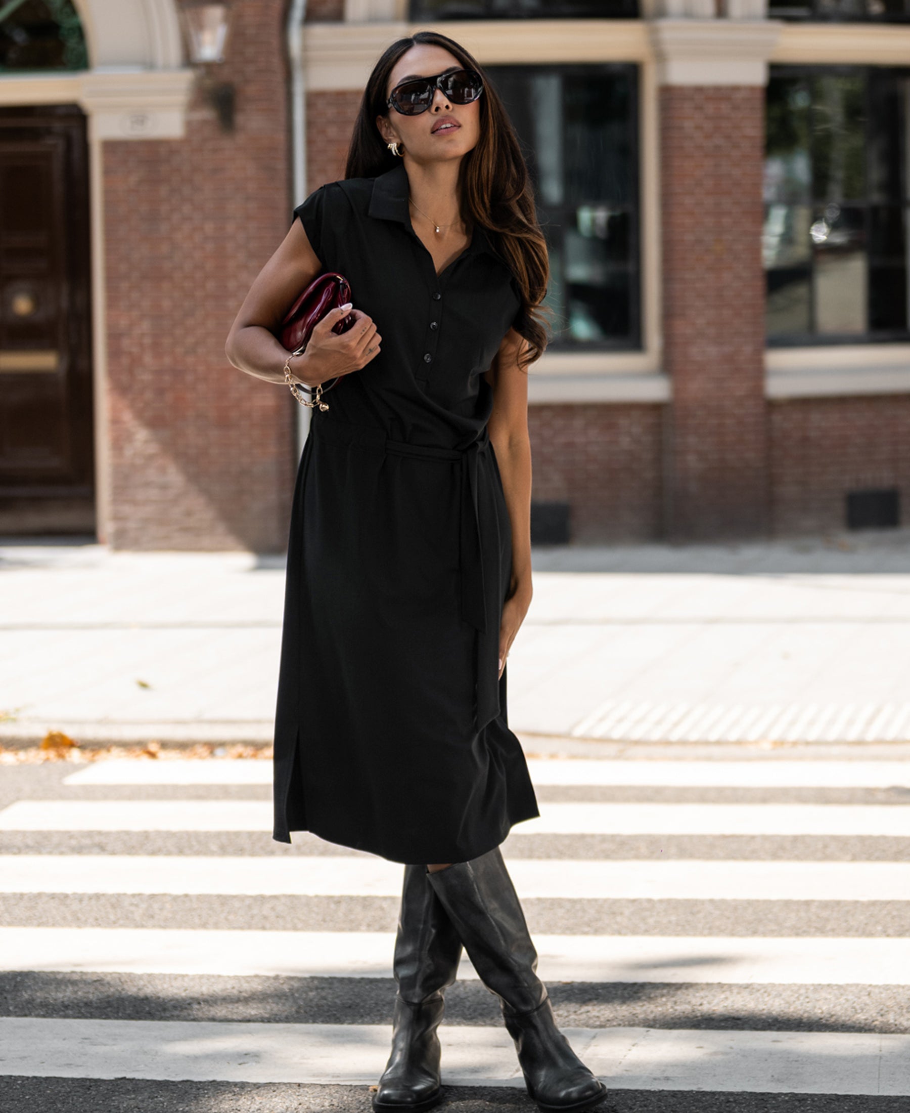 Woman wearing a black PLEIN PUBLIQUE INES Travel polo dress.