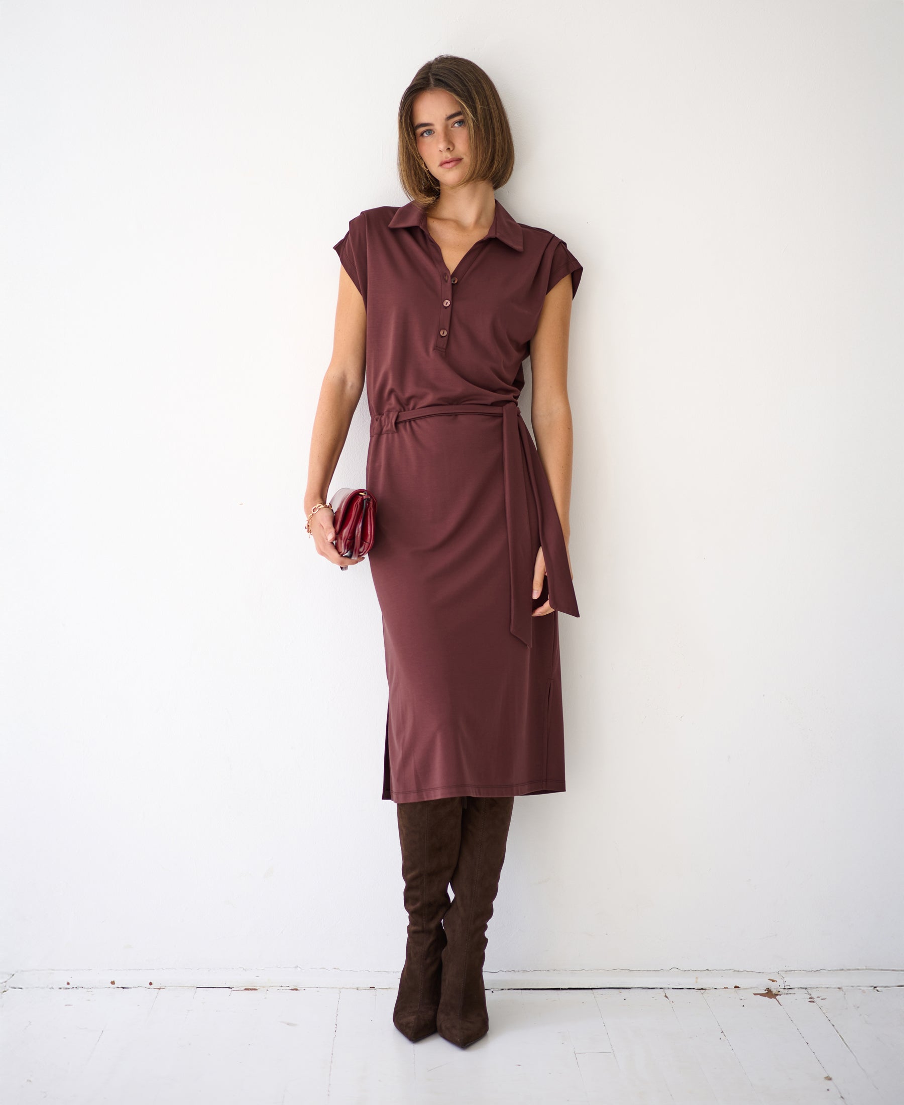 Brown Travel polo dress INES by PLEIN PUBLIQUE, shown on model standing against a white wall.