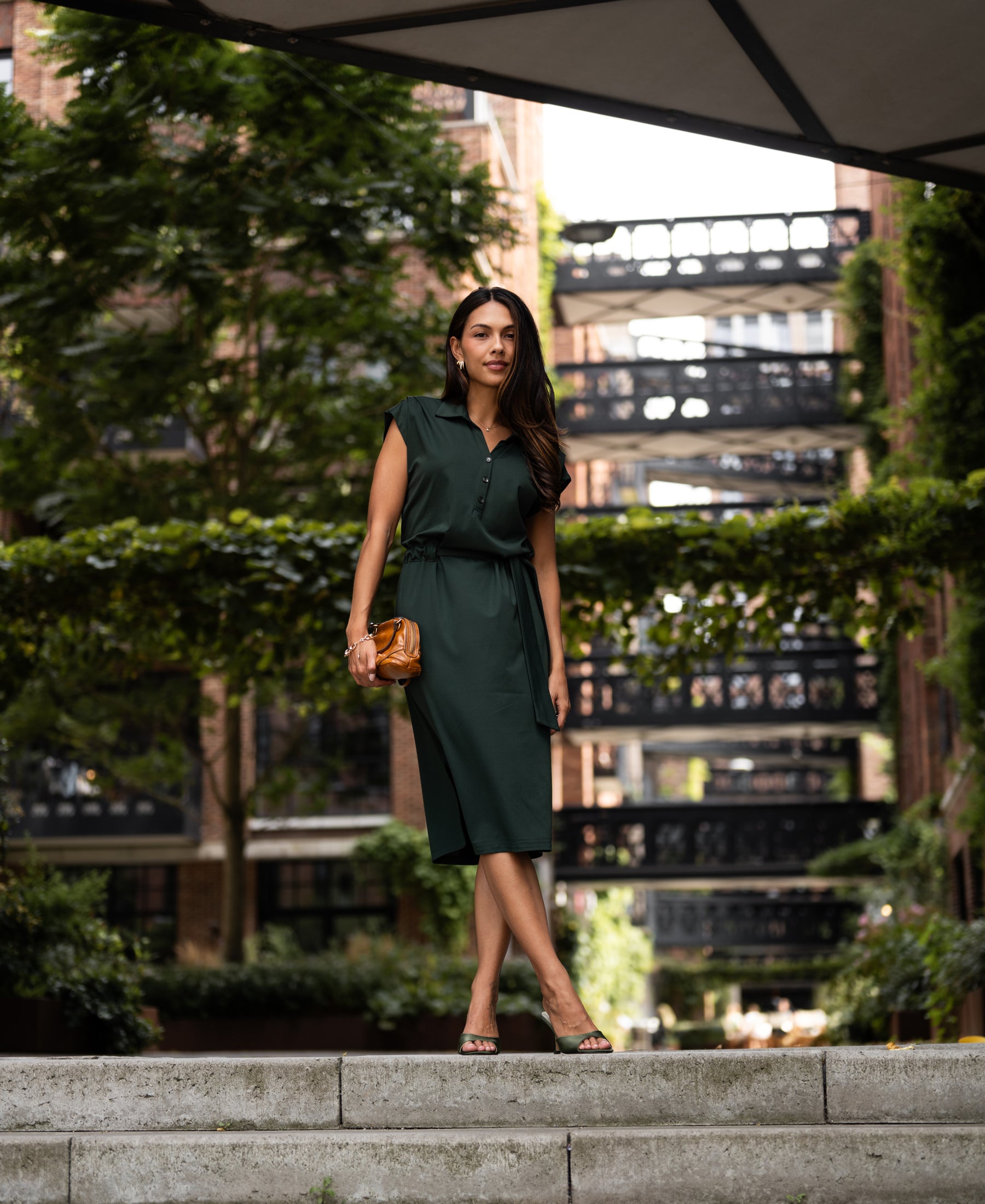 Dark green Travel polo dress by PLEIN PUBLIQUE shown outdoors.