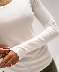 Person wearing an ivory long-sleeve Lyocell T-shirt. Fitted white sleeve visible.