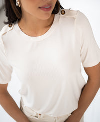 Cream bamboo T-shirt with rib jersey and epaulette details, shown from the shoulders down.