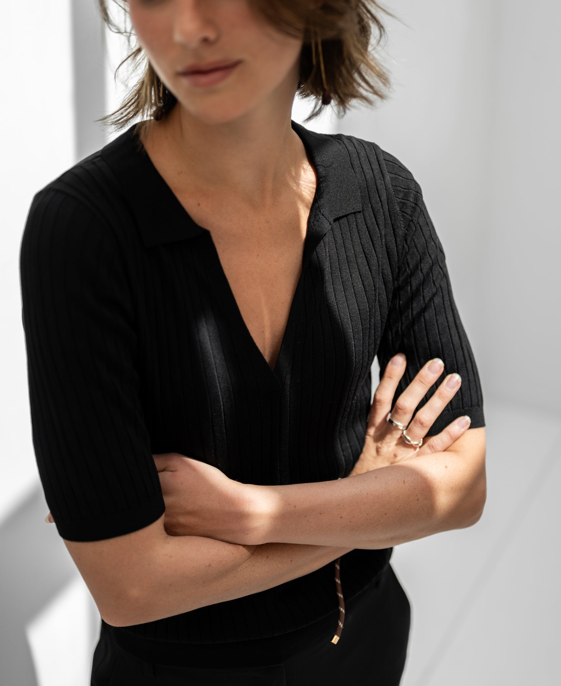 Black Tencel-silk LE JASMIN polo shirt by PLEIN PUBLIQUE shown in bright natural light.