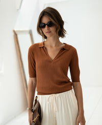 Woman wearing a Havana brown and white Tencel-silk polo shirt, LE JASMIN by PLEIN PUBLIQUE.