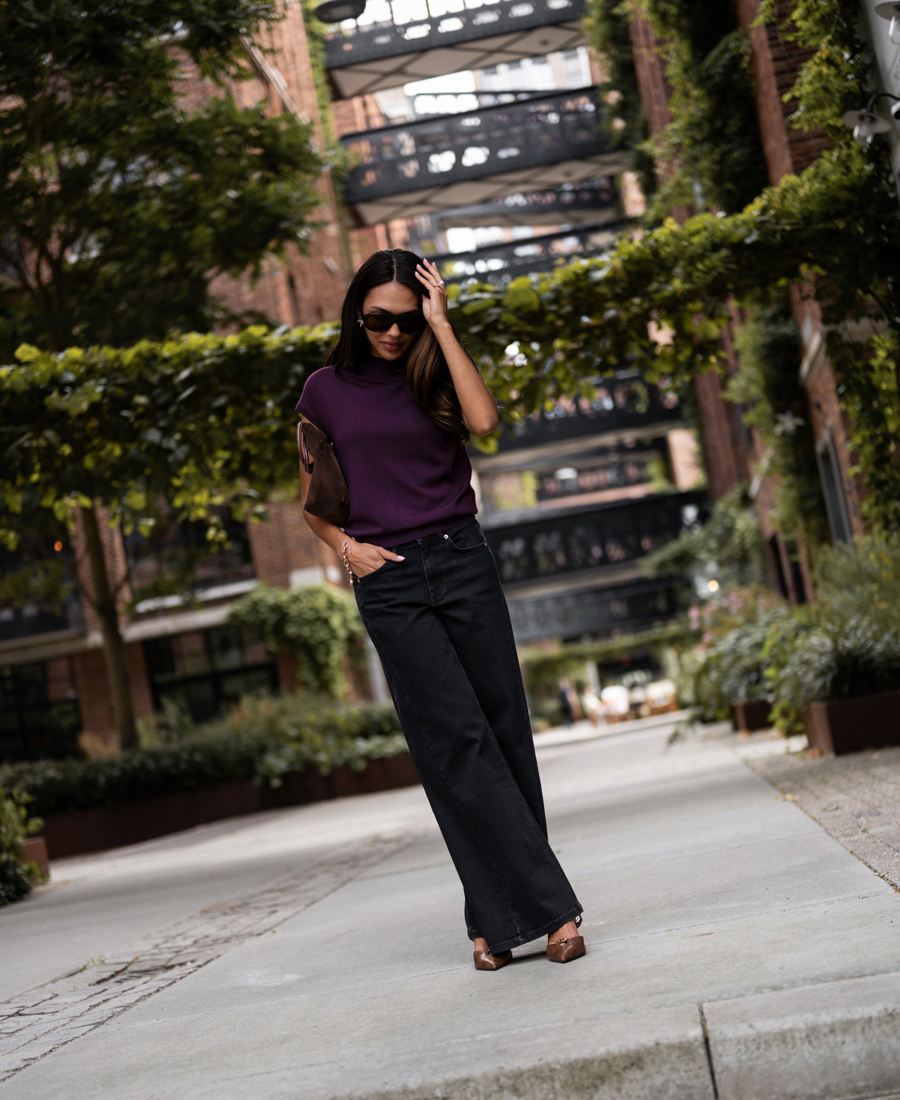 Plum merino wool collared top, shown from the front, worn by a woman outdoors.
