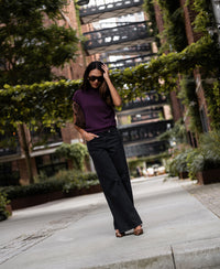 Plum merino wool collared top, shown from the front, worn by a woman outdoors.